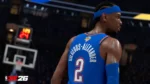 NBA 2K26 screenshot showing Shai Gilgeous-Alexander in Oklahoma City Thunder blue jersey with number 2, viewed from behind in a detailed arena setting with the NBA 2K26 logo visible