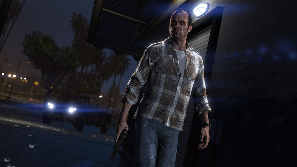 Trevor Philips from Grand Theft Auto V standing at night holding a gun, wearing a plaid shirt against a backdrop of palm trees and city lights.