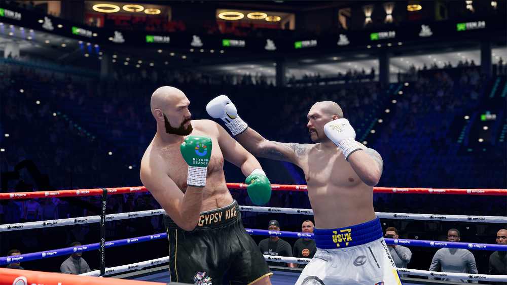 Undisputed boxing game screenshot showing two boxers in a fighting stance inside a professional boxing ring with crowd and lighting effects