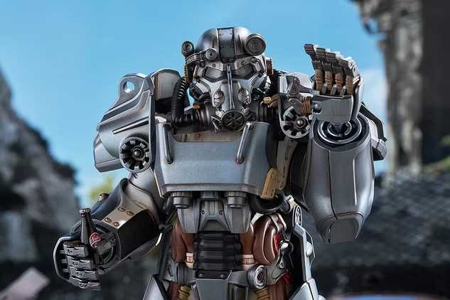 A detailed plastic model kit of the T-60 Power Armor from Fallout, shown in a dynamic pose against a dark background. The model features a weathered paint scheme, the iconic helmet with a headlamp, and is surrounded by its included accessories like a minigun and assault rifle.