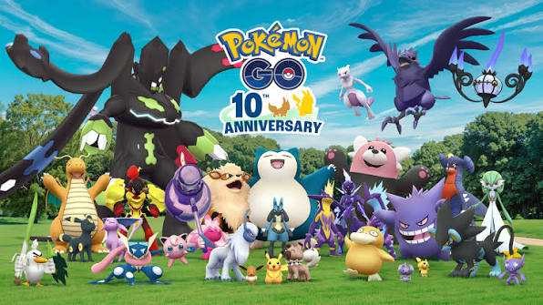 Pokémon GO trainers in Times Square raising their phones during a Mega Mewtwo Y raid at the 10th anniversary event